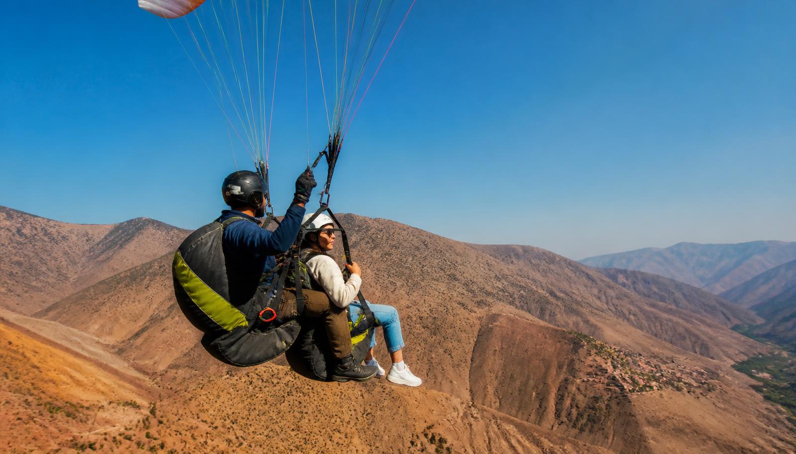 Tandem paraglider in flight with pilot and passenger seated in the harness